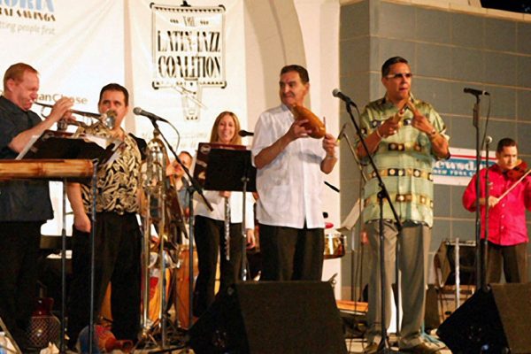 left to right: Steve Gluzband wails on his trumpet solo, Demetrios Kastaris, Solo Rodriguez, Connie Grossman, Hiram Remón, Herman Olivera, Alí Bello, June 16, 2003, Seuffert Bandshell, Woodhaven Queens, New York (photo credit Jerry Lacay)