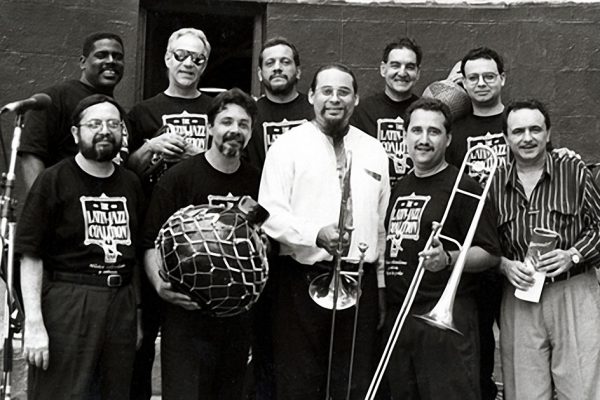 left to right top row: Victor Lewis, Steve Gluzband, Willie Rodriguez, Hiram Remón, Mario Rodriguez, Bottom row: Victor Rendón, Angel Rodriguez, Steve Turre, Demetrios Kastaris, Claudio Roditi, Seuffert Bandshell, Woodhaven Queens, New York, June 26, 1993, (photo credit Kathy Izzo)