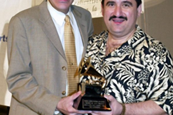 Flautist Dave Valentin displays his Grammy Award for Best Latin Jazz Album- 2003, Caribbean Jazz Project. Picture taken backstage at the Homenaje a Mongo Santamaría Concert, Seuffert Bandshell, Woodhaven Queens, New York, June 16, 2003, Photo credit: Jerry Lacay.