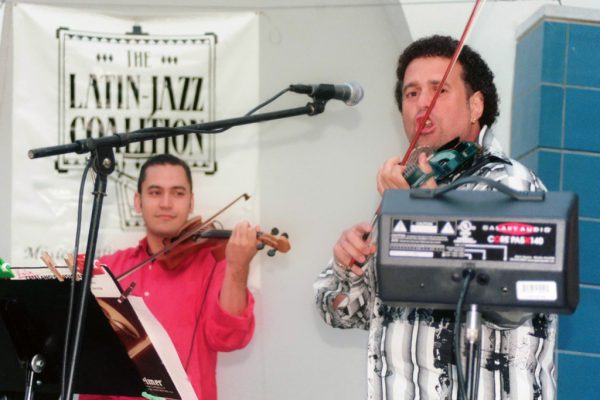 Violin virtuosos Alí Bello and Alfredo de la Fé, June 16, 2003. Homenaje a Mongo Santamaría Concert, Seuffert Bandshell, Woodhaven Queens, New York, Photo credit: Jerry Lacay.