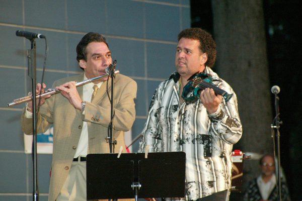 Dave Valentin on flute, Alfredo de la Fé on violin, June 16, 2003, Homenaje a Mongo Santamaría Concert, Seuffert Bandshell, Woodhaven Queens, New York, Photo credit: Jerry Lacay.