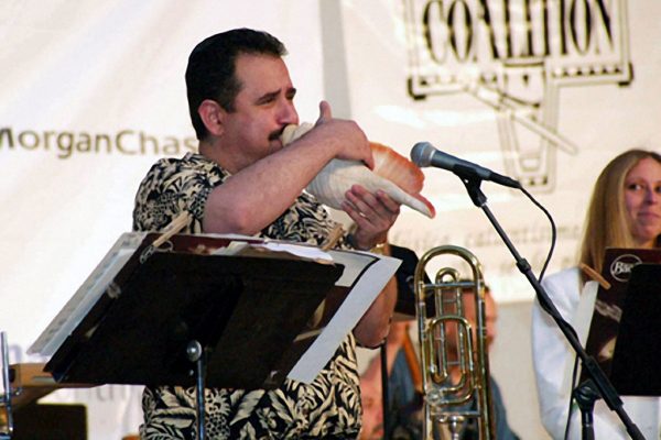 Demetrios Kastaris plays a large conch shell, June 16, 2003, Seuffert Bandshell, Woodhaven Queens, New York (photo credit Jerry Lacay)