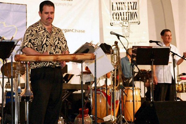 Demetrios Kastaris plays the rumba (cáscara part) on a customized hollow wooden cane (guadua) from South America , Seuffert Bandshell, Woodhaven Queens, New York (photo credit Jerry Lacay)