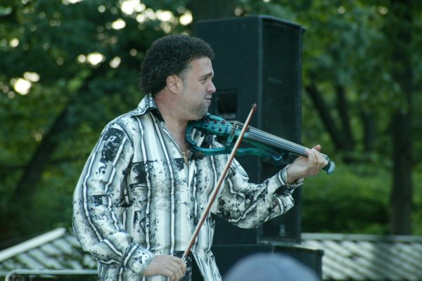 Alfredo de la Fé goes out into the audience to play his heart out, June 16, 2003, Homenaje a Mongo Santamaría Concert, Seuffert Bandshell, Woodhaven Queens, New York, Photo credit: Jerry Lacay.