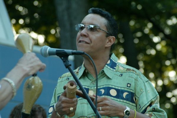 Herman Olivera adds flavor to the Salsa with the claves, June 16, 2003, Homenaje a Mongo Santamaría Concert, Seuffert Bandshell, Woodhaven Queens, New York, Photo credit: Jerry Lacay.