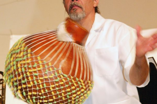Master percussionist Angel Rodriguez on the chékere, June 16, 2003, Homenaje a Mongo Santamaría Concert, Seuffert Bandshell, Woodhaven Queens, New York, Photo credit: Jerry Lacay.