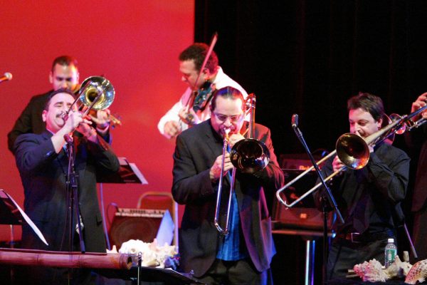 Trombonists fire it up! Demetrios, Steve Turre, Noah Bless, background Alí Bello, Alfredo de la Fé, Queens Theatre in the Park, Flushing New York, December 17, 2004, photo credit Jerry Lacay.
