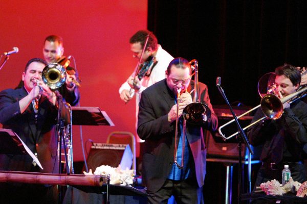 Trombonists fire it up! Demetrios, Steve Turre, Noah Bless, background Alí Bello, Alfredo de la Fé, Queens Theatre in the Park, Flushing New York, December 17, 2004, photo credit Jerry Lacay.