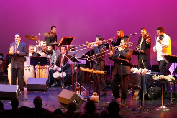 Hiram Remón, Chembo Corniel, Jotan Afanador, Jerome Goldschmidt, Noah Bless, Connie Grossman, Demetrios Kastaris, Alí Bello, Alfredo de la Fé, Queens Theatre in the Park, Flushing New York, December 17, 2004, photo credit Jerry Lacay.